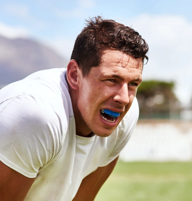 Athlete wearing a custom sports mouthguard